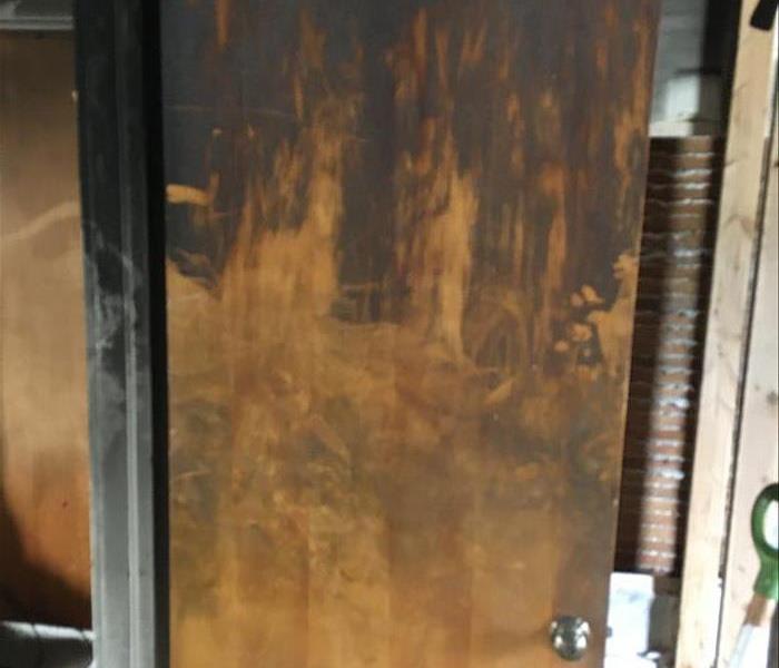 Smoke and soot covered door from cigar fire