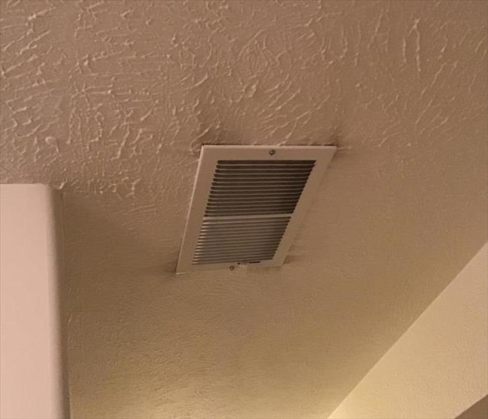 Soot on ceiling around air vent.
