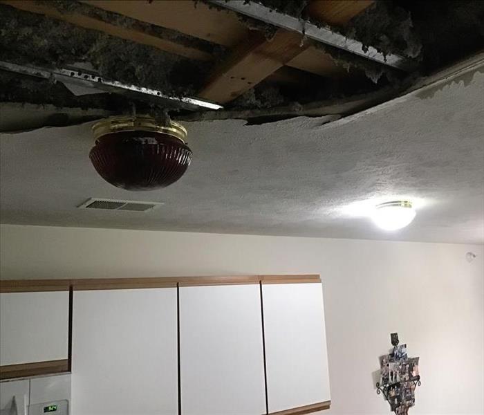 Water filled light fixture in kitchen with ceiling collapsed