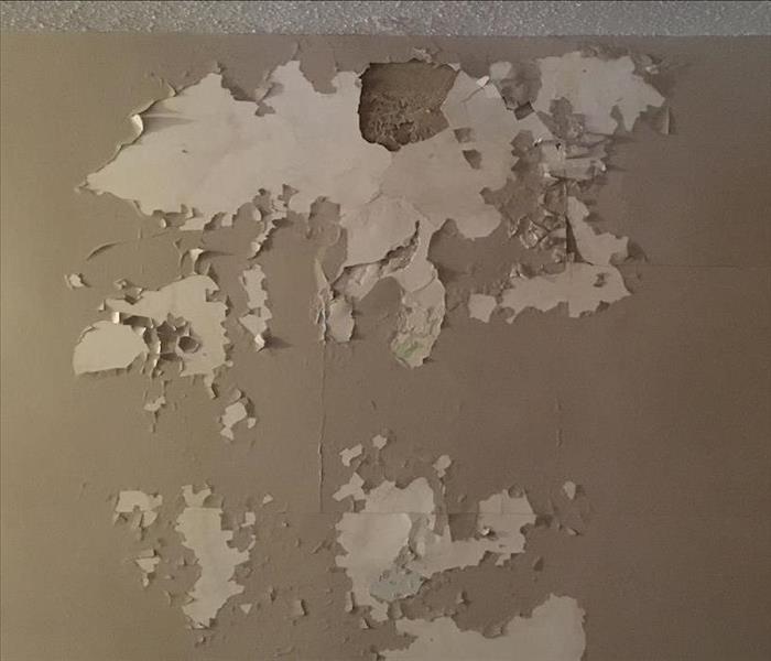 Paint peeling from excessive moisture after water damage